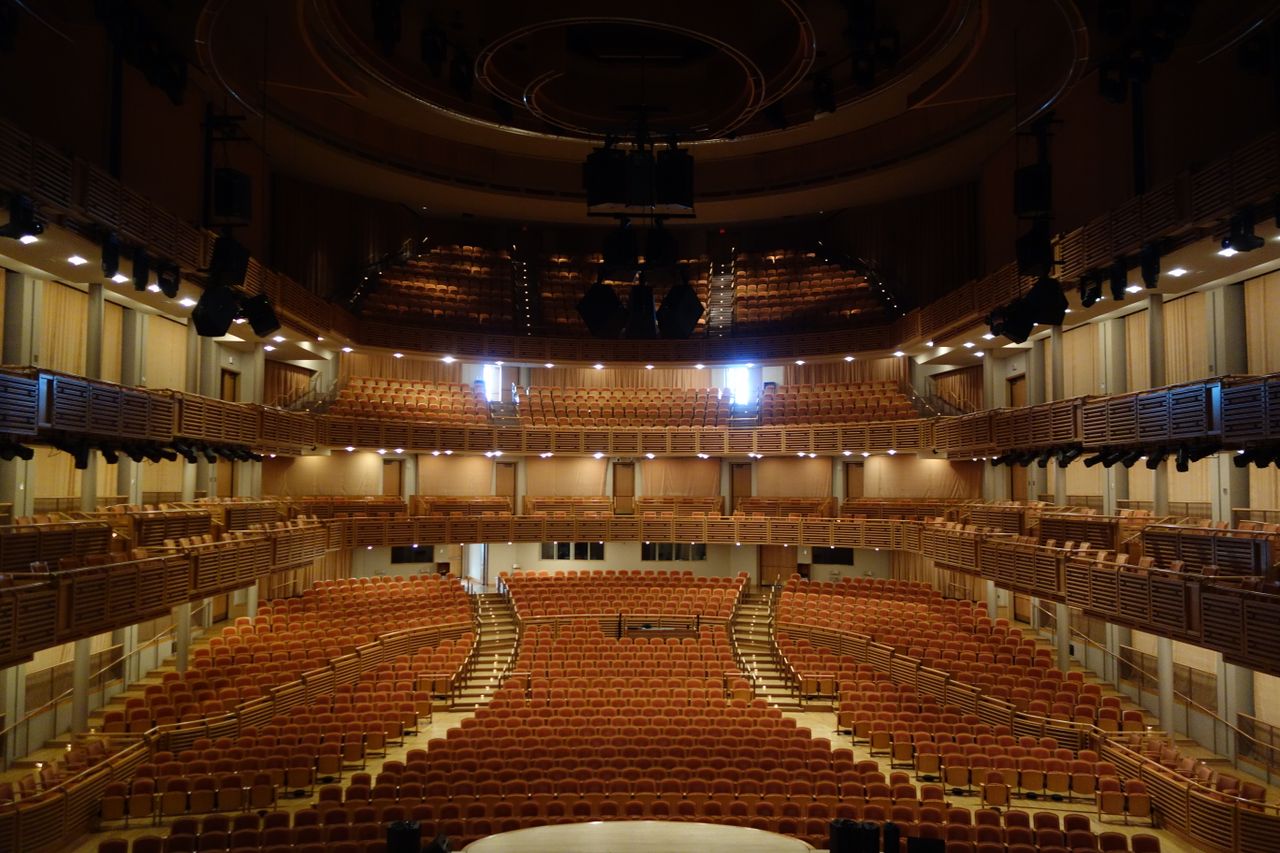 A modern, well-lit theater auditorium with empty seating in Miami, Florida.